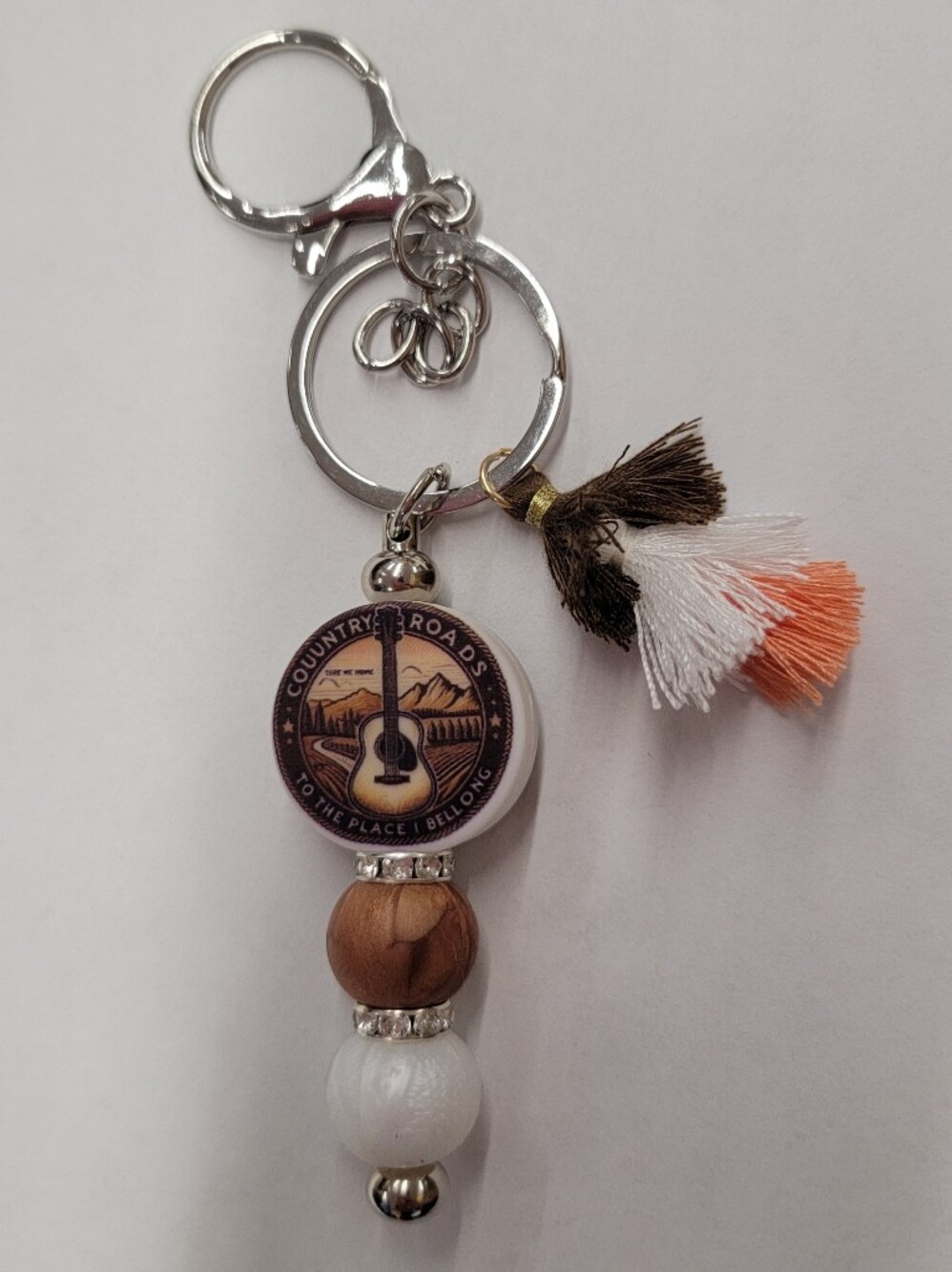 "Country Roads Take Me Home"Guitar Emblem Tassel Keychain - Brown, White & Coral